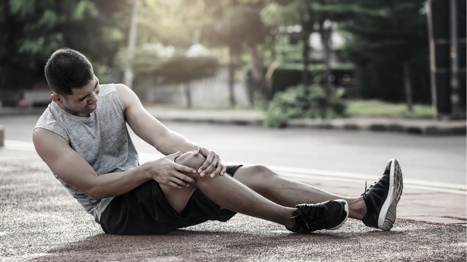 man with injured knee during sports